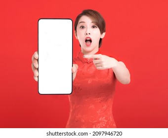 Happy chinese new year. excited young Woman showing blank smart phone screen