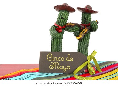 Happy Cinco De Mayo Concept With Fun Mariachi Band Cactus Players And Greeting Card On Red Wood Table. 