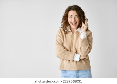 Happy clever excited young woman student pointing finger up getting new eureka idea, finding answer, showing presenting wow trendy amazing promotion offer standing isolated at white background. - Shutterstock ID 2289568031