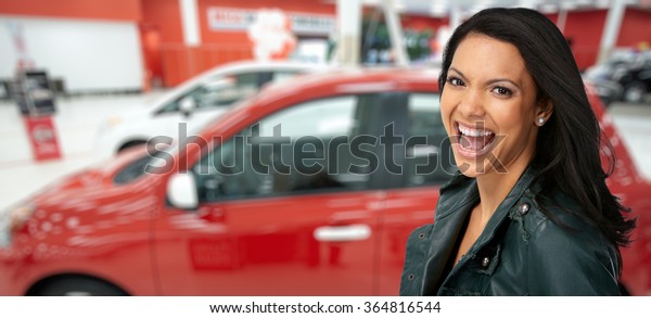 Happy client woman near red
car.