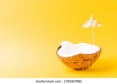 Happy Coconuts Day Concept, Fresh Coconut And Sun Umbrella, Studio Shot Isolated On Yellow Background, Beach Tropical Fruit Spring Summer Holiday