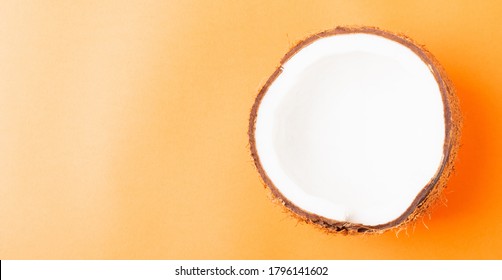 Happy Coconuts Day Concept, Fresh Half Coconut, Studio Shot Isolated On Orange Background