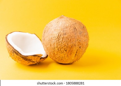 Happy Coconuts Day Concept, Fresh Full Coconut With Half Coconut, Studio Shot Isolated On Yellow Background