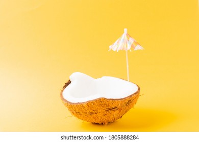 Happy Coconuts Day Concept, Fresh Coconut And Sun Umbrella, Studio Shot Isolated On Yellow Background, Beach Tropical Fruit Spring Summer Holiday