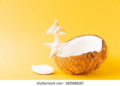 Happy Coconuts Day Concept, Fresh Coconut, Starfish And Sun Umbrella, Studio Shot Isolated On Yellow Background, Beach Tropical Fruit Spring Summer Holiday