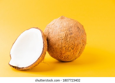 Happy Coconuts Day Concept, Fresh Full Coconut With Half Coconut, Studio Shot Isolated On Yellow Background