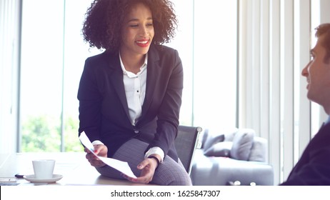 Happy colleague African woman and Hispanic man consulting work positive attitude - Shutterstock ID 1625847307