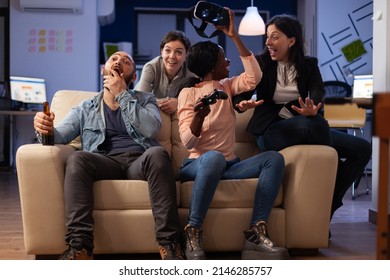 Happy Colleagues Using Vr Glasses On Video Games Play With Controller, Having Fun With Drinks After Work Hours. Business People Enjoying Leisure Activity With Virtual Reality Goggles At Office Party.