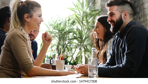 Happy colleagues from work socializing in restaurant - Shutterstock ID 1479417308
