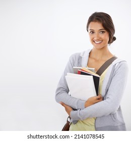 So Happy At College. Cropped Studio Shot Of A College Student Smiling Widely With Books In Her Arms.