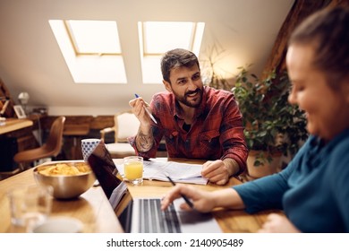 Happy College Roommates Communicating While Learning Together At Home. Focus Is On Man.