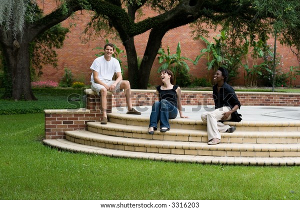 happy college\
students hanging out on\
campus