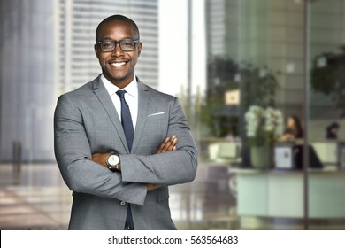 Happy company leader CEO boss executive standing in front of company building - Powered by Shutterstock