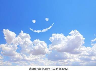 Happy concept. Smilie from white cloud in the blue sky 