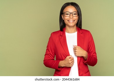 Happy confident african american businesswoman, successful entrepreneur or small business owner female cheerful smiling and looking in camera. Black woman in eyeglasses and red jacket over studio wall