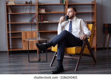 Happy confident business man drinking coffee