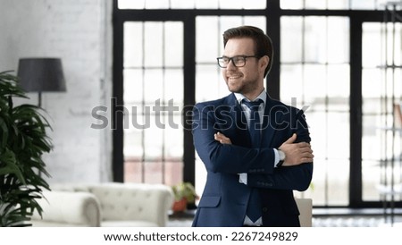 Happy confident business owner, CEO, company leader looking away, smiling, thinking of future profit and success. Head shot portrait of successful businessman in glasses in office. Leadership concept