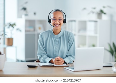 Happy And Confident Call Center Agent Sitting In Front Of A Laptop While Wearing A Headset In An Office. Portrait Of A Cheerful Saleswoman Using Web Chat To Assist Customer Sales And Service Support