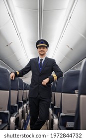 Happy confident caucasian pilot in airplane salon - Shutterstock ID 1972844732