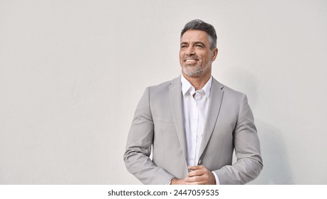 Happy confident mature business man looking away isolated on white wall. Rich middle aged businessman ceo entrepreneur, smiling older professional executive, male investor thinking of future success. - Powered by Shutterstock