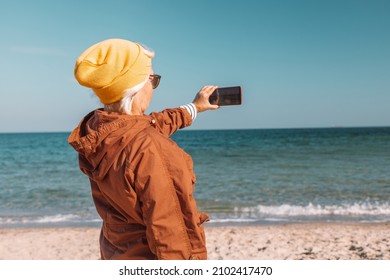 Happy Confident Mature Woman Taking Picture Of The Sea Using Smartphone, Enjoying Ocean View