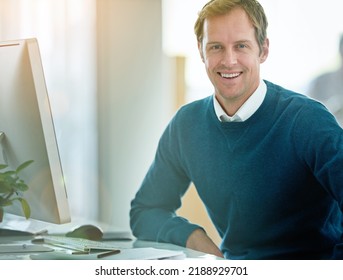 Happy, confident and smiling businessman sitting at his desk and feeling satisfied with his career and job choice. Portrait of a motivated and proud male entrepreneur working to grow his startup - Shutterstock ID 2188929701