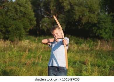 Happy Confident Young Kid Playing Outdoor In Summer Sunny Sunset Landscape. Setting Goals And Aims Concept. Horizontal Color Photography.