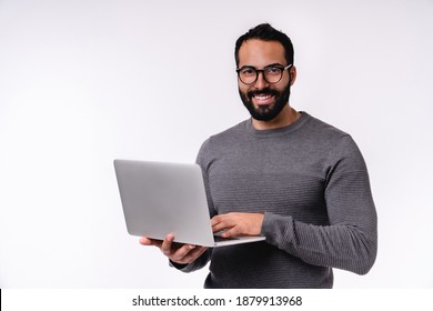 Happy confident young Middle East man using laptop isolated over white background - Shutterstock ID 1879913968