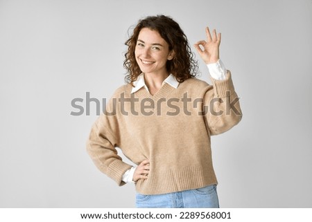 Happy confident young woman model showing ok hand gesture, smiling pretty lady giving recommendation with okay sign advertising product or service standing isolated on white background.