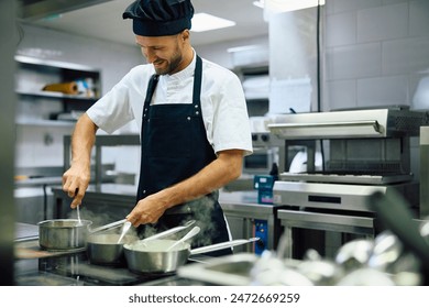 Happy cook preparing food while working in restaurant.  - Powered by Shutterstock