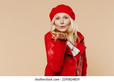 Happy Coquette Cheery Elderly Gray-haired Blonde Woman Lady 40s Years Old Wears Red Beret Jacket Dress Looking Camera Blowing Sending Air Kiss Isolated On Plain Pastel Beige Background Studio Portrait