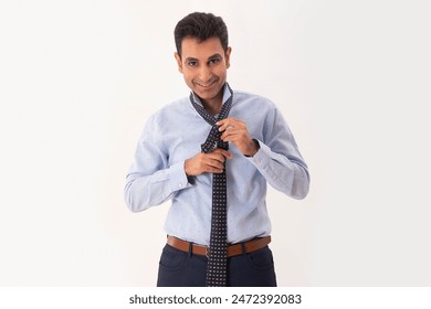 A HAPPY CORPORATE EMPLOYEE LOOKING AT CAMERA AND WEARING TIE - Powered by Shutterstock