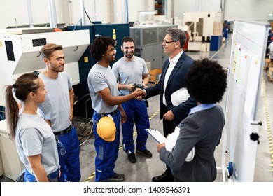 Happy Corporate Manager Taking A Tour In A Factory And Shaking Hands With African American Worker. 