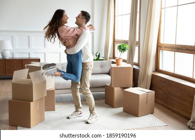 Happy couple arrive at bought house, cheerful husband lifts up on hands beloved wife family begin new life at first dwelling. Loan and mortgage, bank lending, delivered goods satisfied clients concept