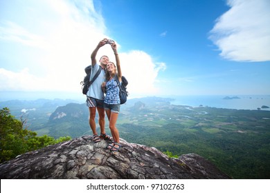 Happy Couple With Backpacks Making A Snapshot Of Themselves On Top Of A Mountain