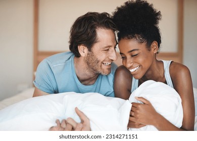 Happy couple, bed and laughing in relax for morning, bonding or intimate relationship at home. Interracial man and woman smiling with laugh in joyful happiness or relaxing weekend together in bedroom - Powered by Shutterstock