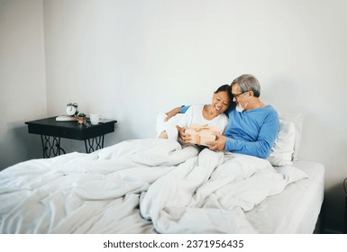 Happy couple in bed, mature or hug for gift for anniversary, care or love in home, house or retirement. Giving, Asian man or excited senior woman with birthday present box for romance in bedroom - Powered by Shutterstock