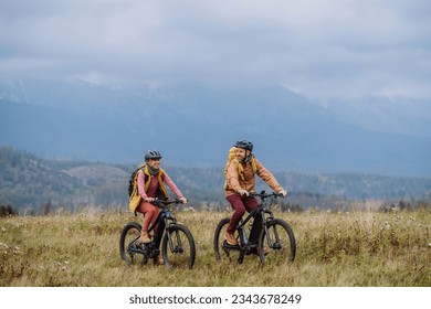 Happy couple at bicycles, in the middle of autumn nature. Concept of a healthy lifestyle. - Powered by Shutterstock