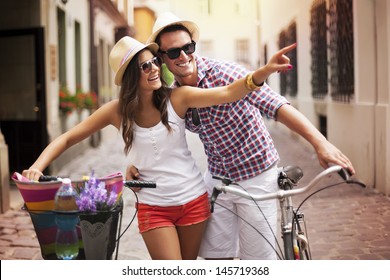 Happy couple with bikes in the city - Powered by Shutterstock