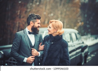 Happy Couple At Black Vintage Retro Car. Friends Going On Road Trip Travel On Winter Day.