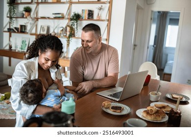 Happy couple bonding while mother breastfeeds baby at home - Powered by Shutterstock