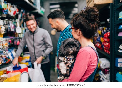 Happy Couple Buying Food For Their Dog In Pet Shop.