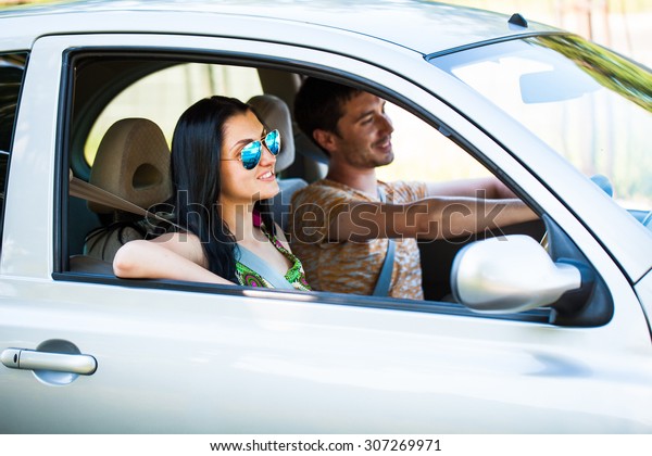 Happy couple in the\
car
