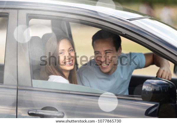 Happy couple with car\
dealer