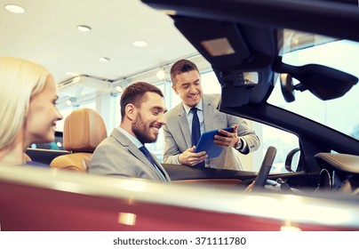 Happy Couple With Car Dealer In Auto Show Or Salon