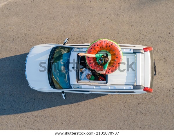 happy couple in car overhead view car travel to\
sea concept sunroof