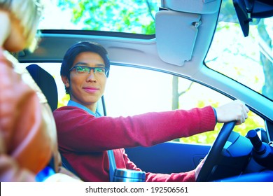 Happy Couple In A Car With Sun Shining Through The Window