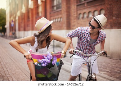 Happy Couple Chasing On Bike In The Street