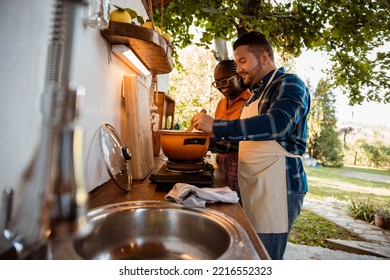 Happy Couple Cooking Together In Rustic Kitchen. Close Up Multiracial Friends Preparing Food