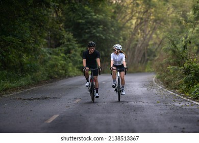 happy couple cycle or ride bicycle on rode in countryside for health life style - Powered by Shutterstock